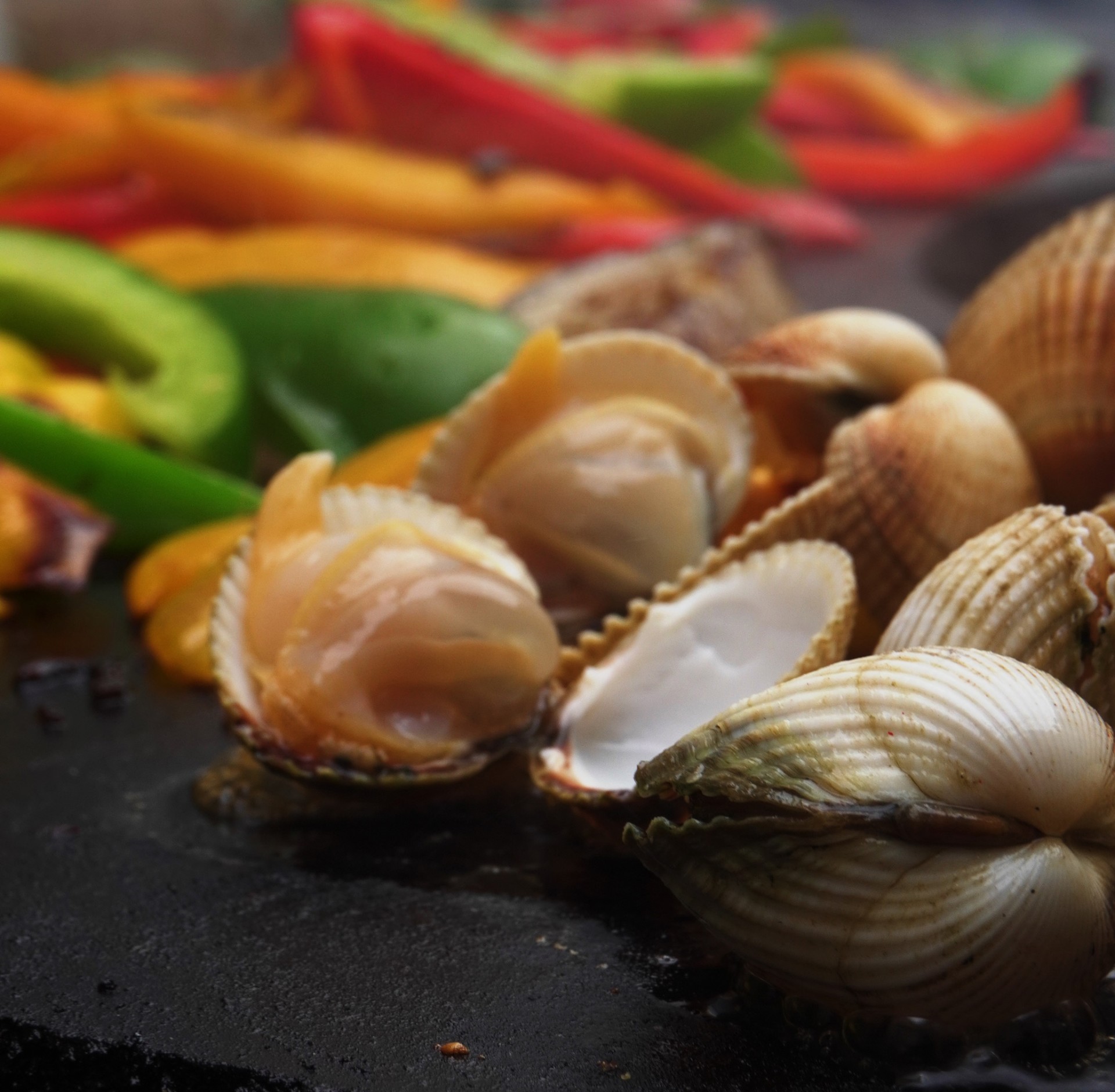 Coques et légumes grillés à la plancha, cuisine à la flamme signature de la Guinguette du Peyrat. - réalisé par Agence Kulte